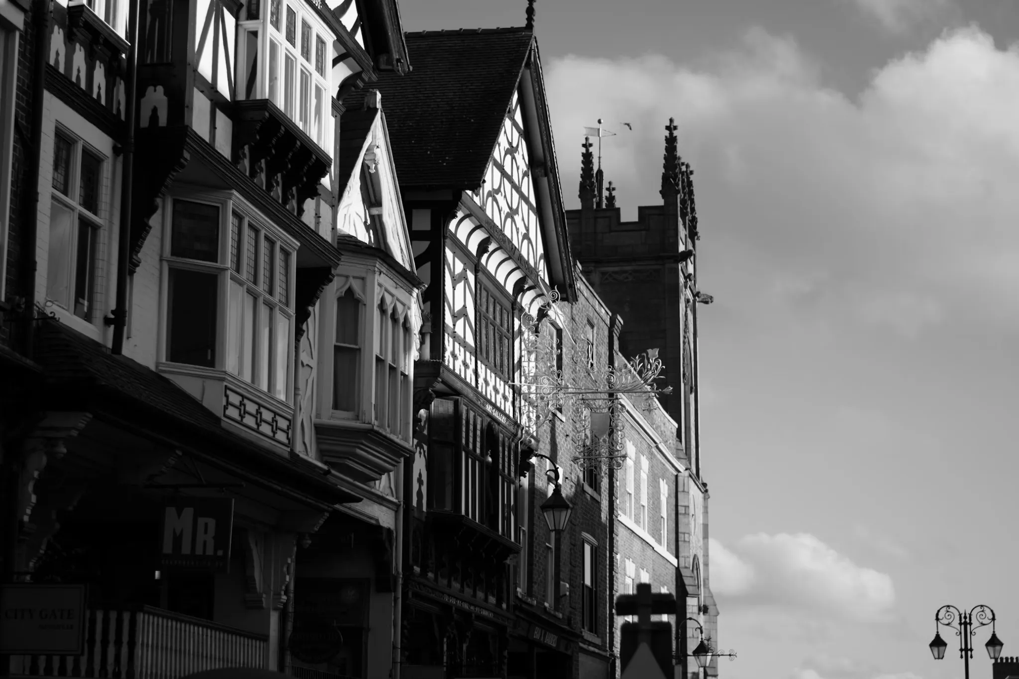 Black and white image of a row of Tudor style houses