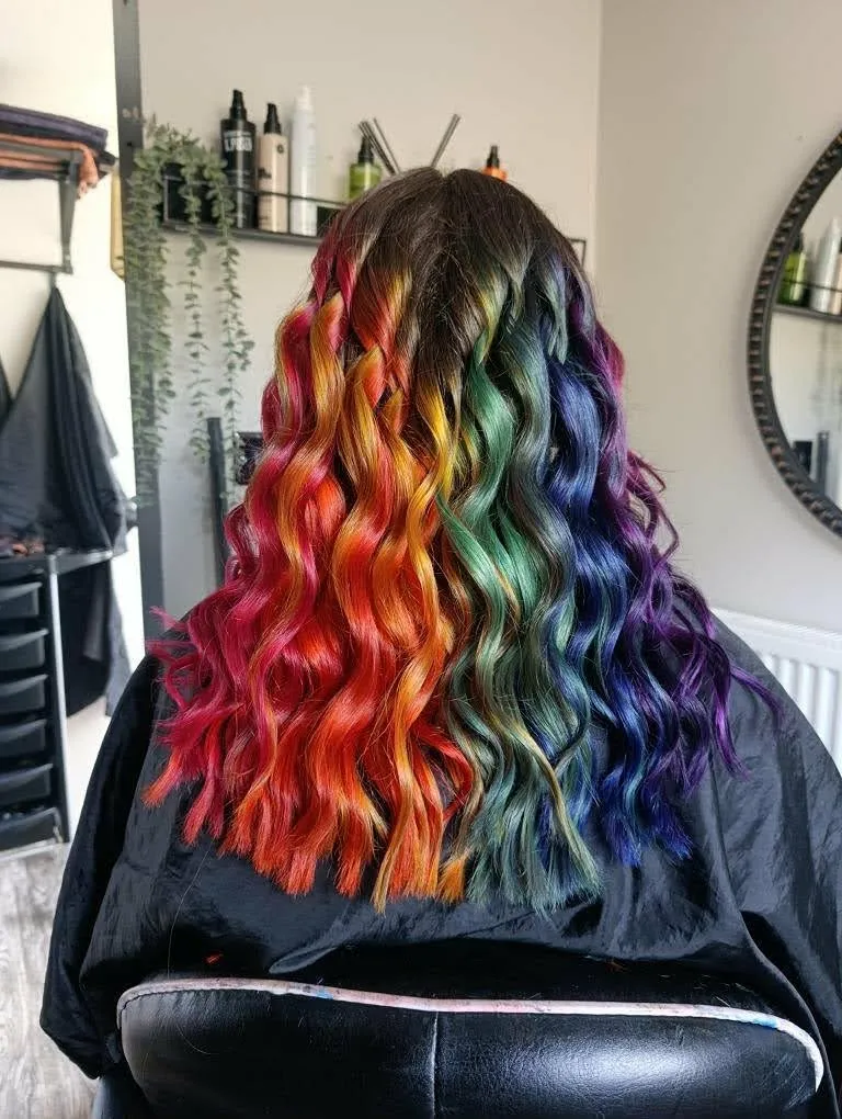 Curly hair, with a rainbow fading to natural hair at the top. From left-to-right the colors are: red, orange, yellow, green, blue, purple.
